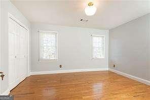 unfurnished bedroom featuring a closet and light wood-type flooring