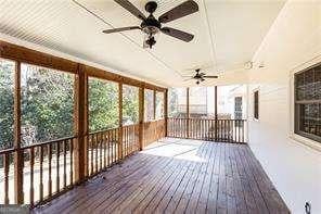 unfurnished sunroom featuring a healthy amount of sunlight and ceiling fan