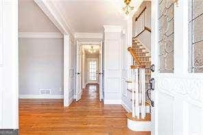 corridor featuring crown molding and wood-type flooring