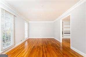 interior space with ornamental molding and wood-type flooring