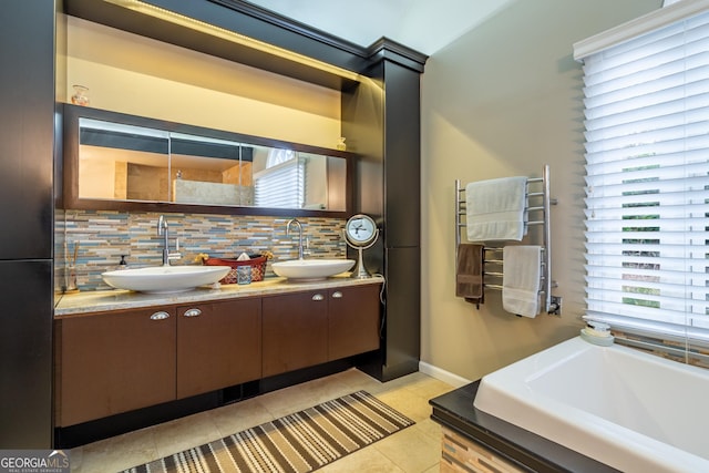 bathroom featuring radiator heating unit, a bath, vanity, tile patterned flooring, and backsplash