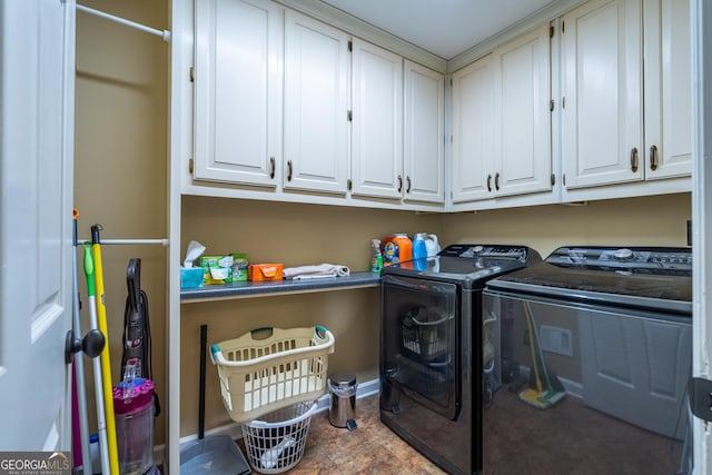 laundry room with cabinets and washer and dryer