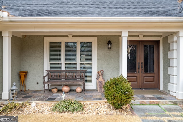 doorway to property featuring french doors and covered porch