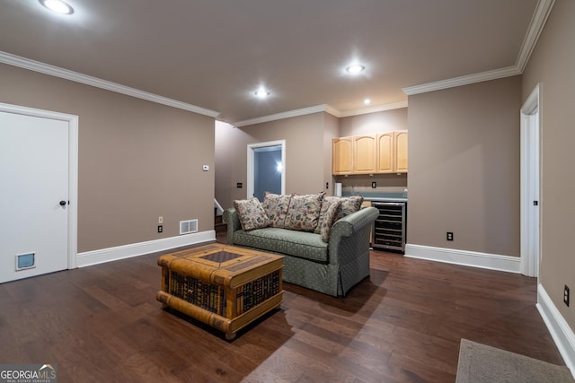 living room with bar, crown molding, dark wood-type flooring, and beverage cooler