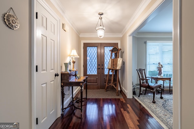 entrance foyer with ornamental molding, dark hardwood / wood-style floors, and french doors