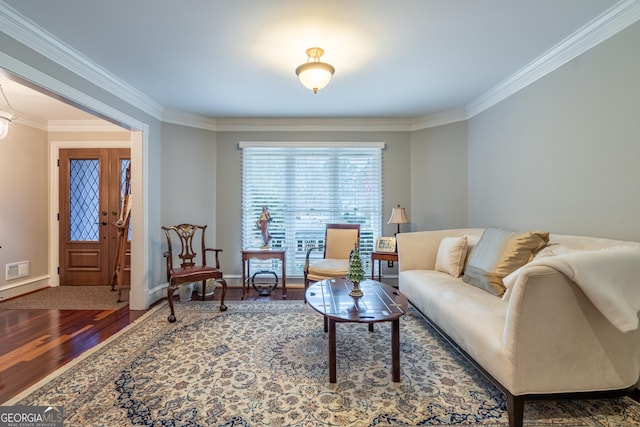 living room with hardwood / wood-style floors and ornamental molding