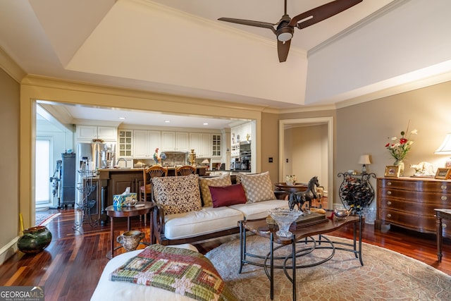 living room with ceiling fan, ornamental molding, and dark hardwood / wood-style flooring