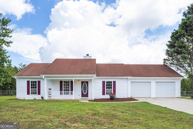 view of front facade with a chimney, a porch, concrete driveway, a garage, and a front lawn