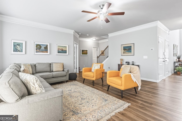 living room with crown molding, ceiling fan, baseboards, stairway, and wood finished floors