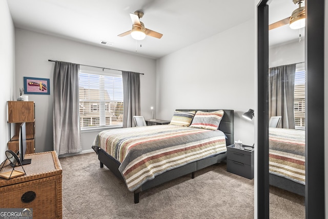 bedroom featuring visible vents, a ceiling fan, and carpet floors