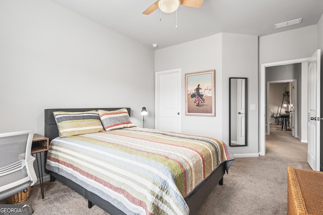 carpeted bedroom with visible vents, baseboards, and ceiling fan