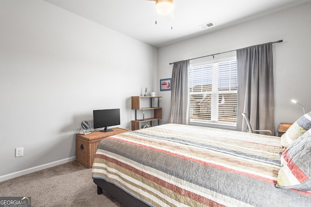 carpeted bedroom with visible vents, ceiling fan, and baseboards