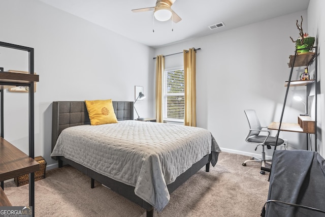 carpeted bedroom featuring visible vents, baseboards, and ceiling fan