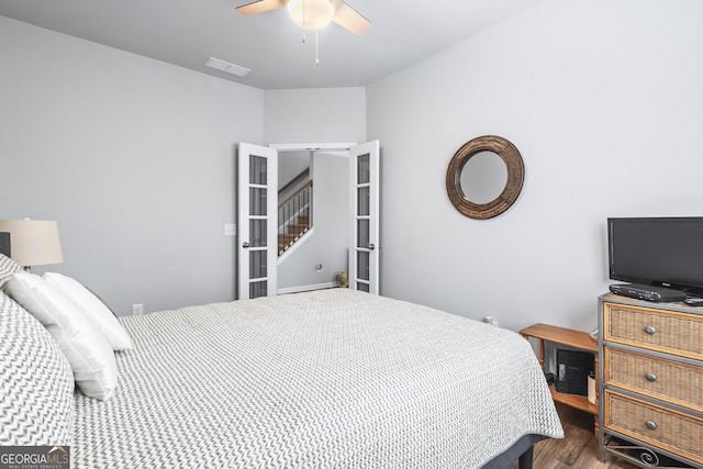 bedroom with visible vents, a ceiling fan, and wood finished floors