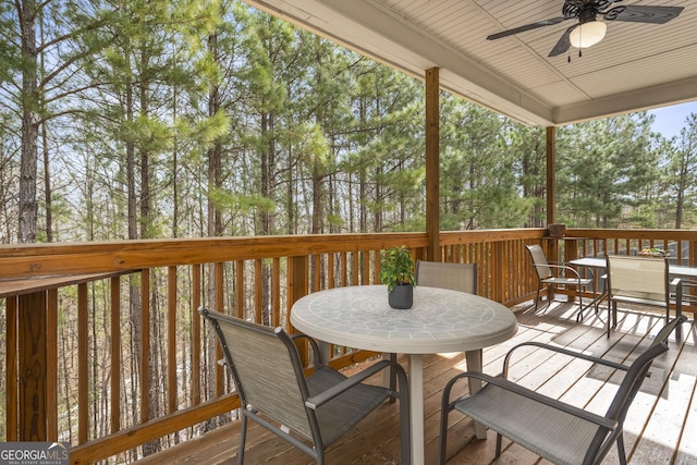 wooden deck featuring ceiling fan and outdoor dining space