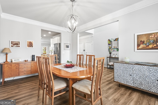 dining room with dark wood-type flooring, a notable chandelier, and crown molding