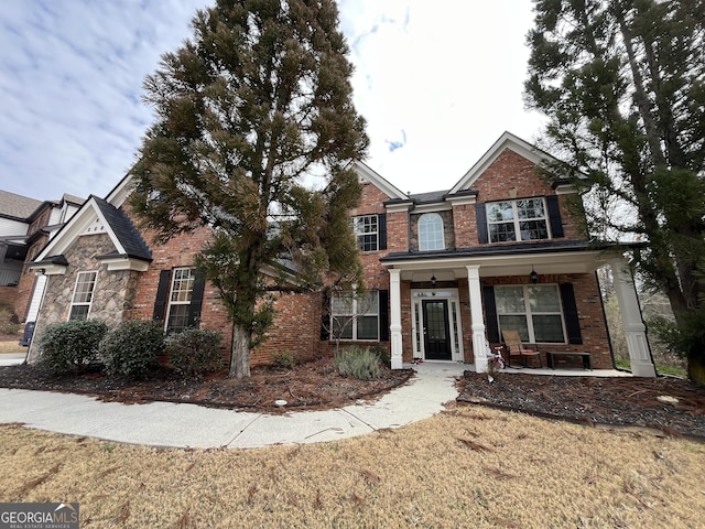 view of front of property with a front yard and a porch