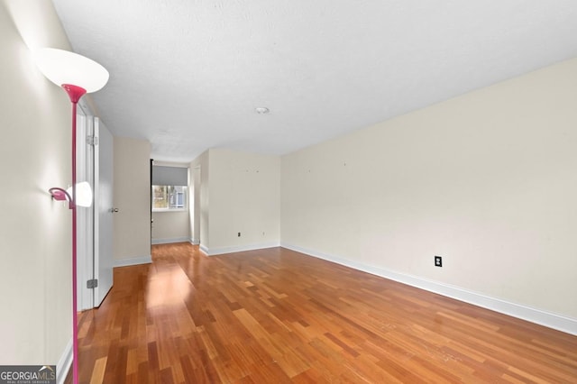 empty room with wood-type flooring