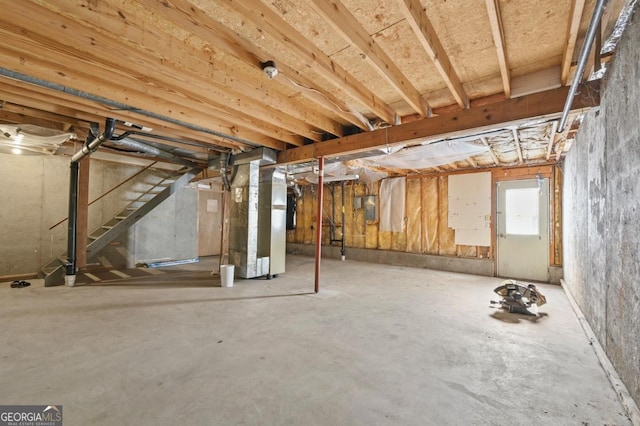 basement with electric panel and heating unit