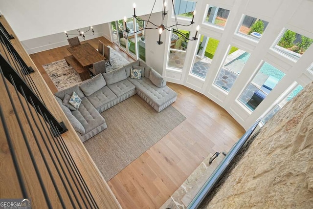 living area featuring a chandelier and wood finished floors