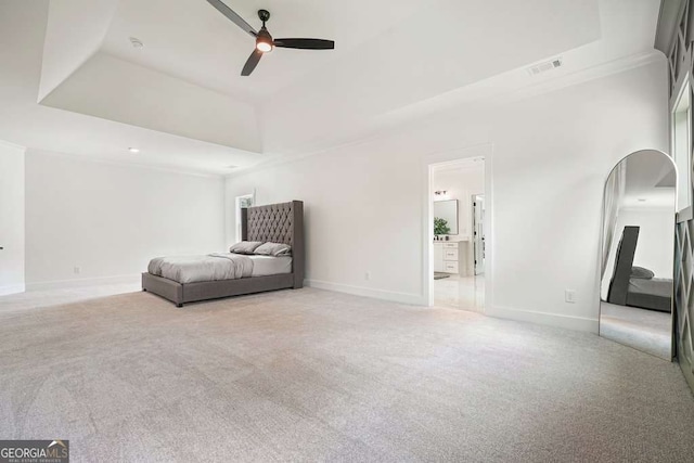 unfurnished room featuring light carpet, baseboards, visible vents, and a raised ceiling