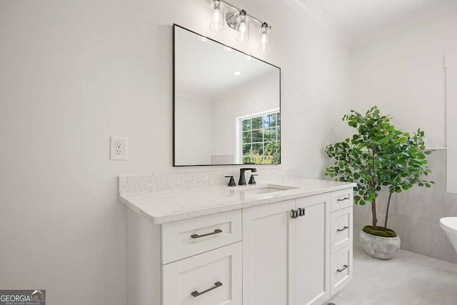 bathroom with toilet, tile walls, vanity, and crown molding