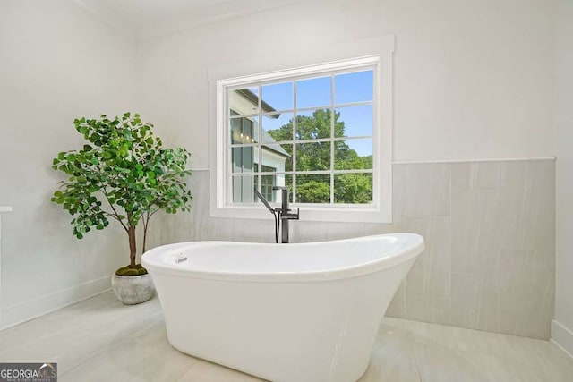 full bath featuring tile walls and a freestanding bath