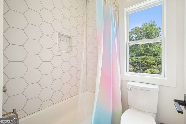 bathroom with shower / tub combo and toilet