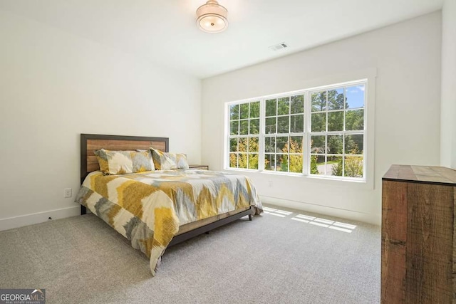 bedroom with carpet flooring, visible vents, and baseboards