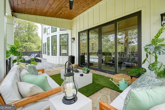 sunroom / solarium featuring wooden ceiling