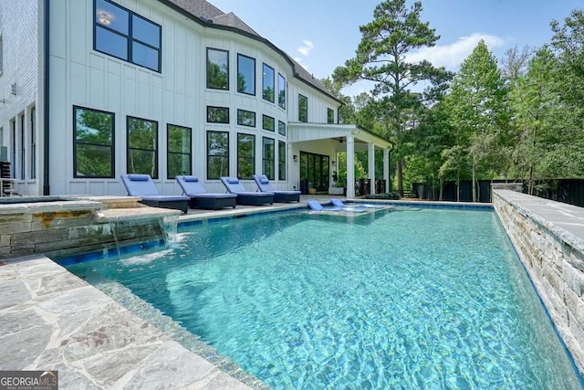 view of pool with a pool with connected hot tub