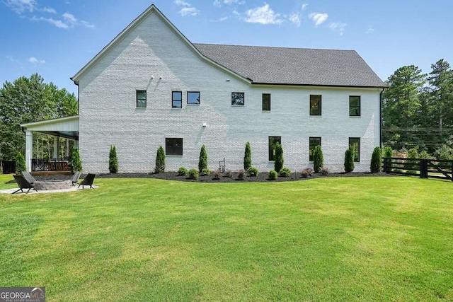 view of property exterior featuring a lawn and fence