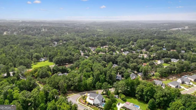 birds eye view of property with a forest view and a residential view