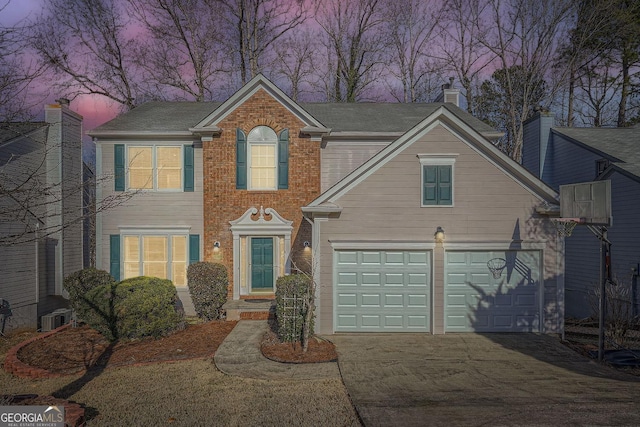 view of front of house featuring a garage and central AC unit