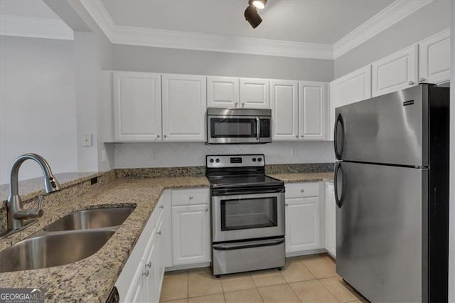 kitchen with sink, ornamental molding, appliances with stainless steel finishes, dark stone counters, and white cabinets