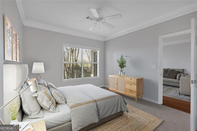 bedroom with crown molding, carpet floors, and ceiling fan