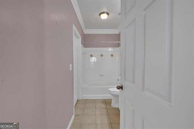 bathroom with crown molding, tile patterned floors, toilet, and tiled shower / bath combo