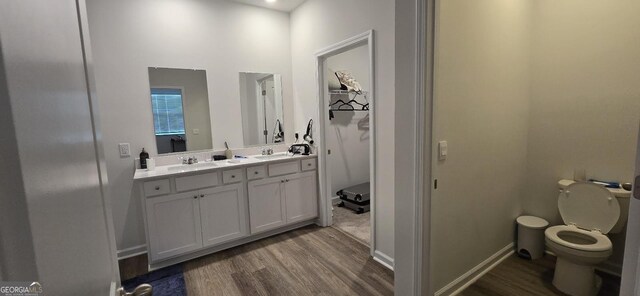 bathroom with vanity, hardwood / wood-style flooring, and toilet