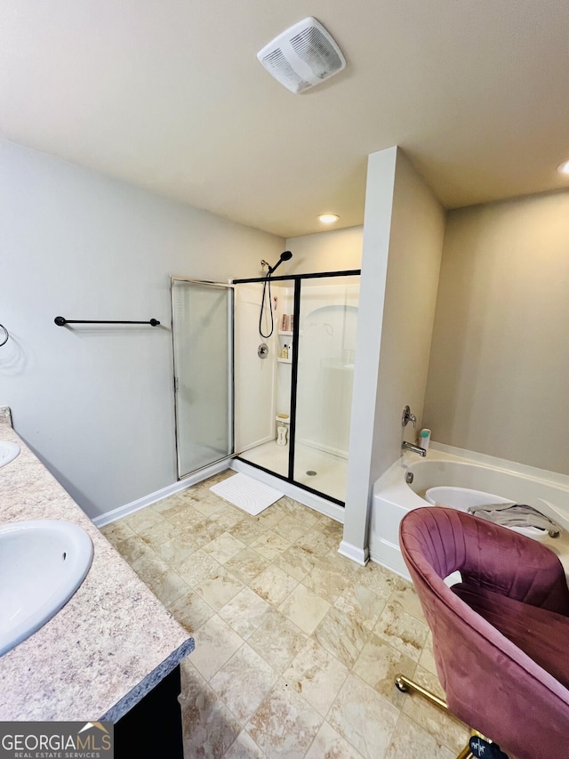 bathroom with vanity and independent shower and bath