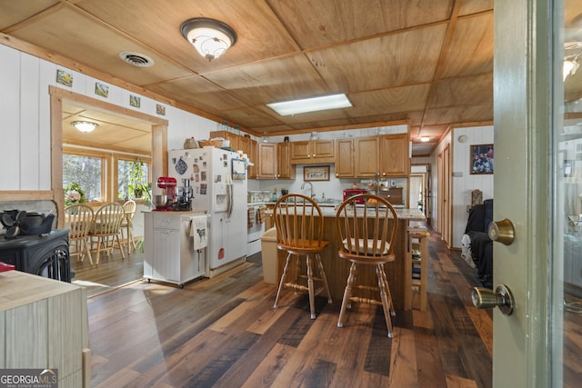 dining area featuring dark wood-type flooring and wooden ceiling