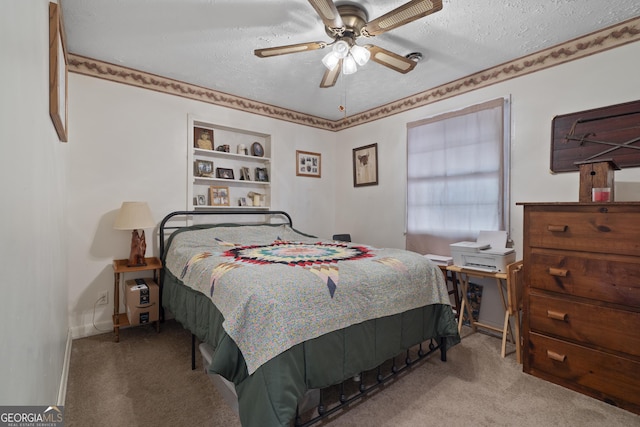 carpeted bedroom featuring ceiling fan and a textured ceiling