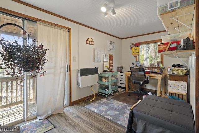 office with ornamental molding, wood-type flooring, and heating unit