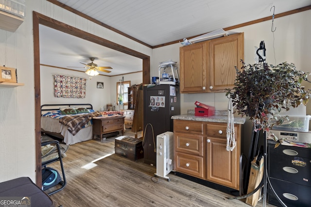 kitchen featuring crown molding, ceiling fan, and wood-type flooring