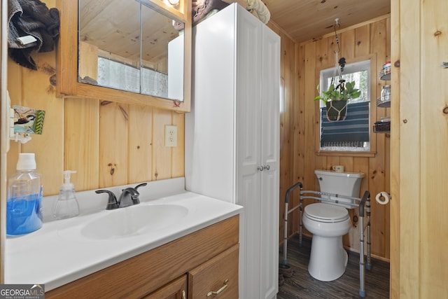 bathroom featuring vanity, wood-type flooring, wooden ceiling, toilet, and wood walls