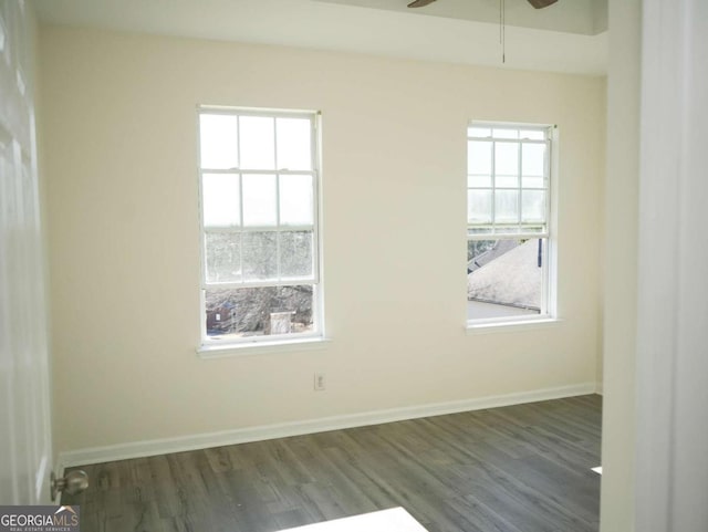 empty room featuring dark wood-type flooring and ceiling fan