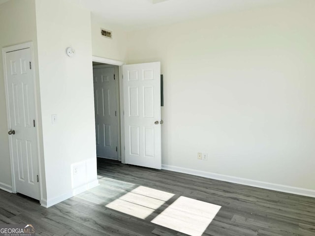 unfurnished room featuring dark hardwood / wood-style floors