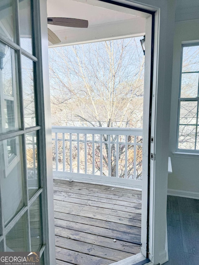 doorway to outside with hardwood / wood-style floors and ceiling fan