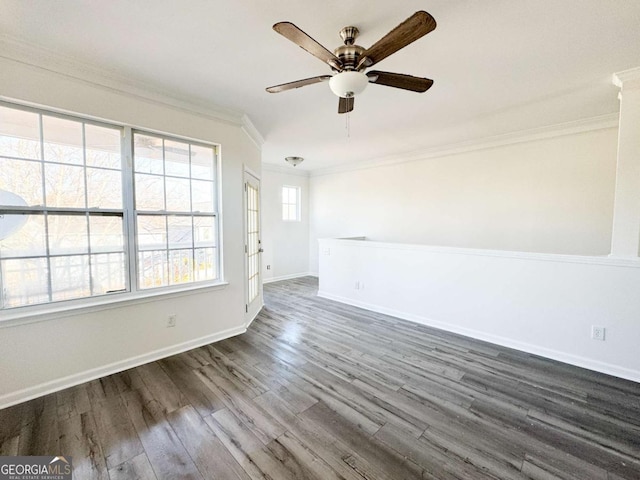 empty room with dark hardwood / wood-style flooring, crown molding, and ceiling fan