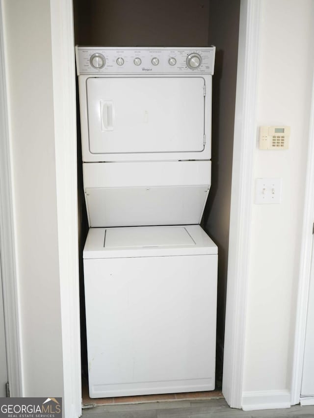 washroom with stacked washer and dryer