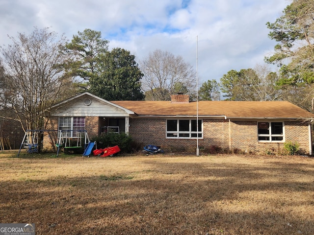 back of property featuring a lawn